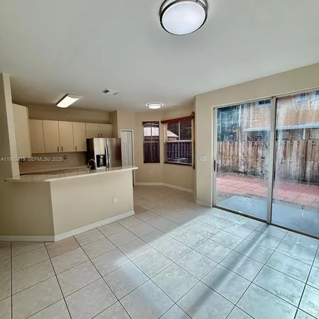 a large white kitchen with a sink and cabinets