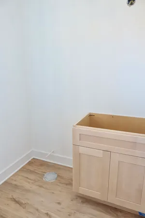 a utility room with wooden floor