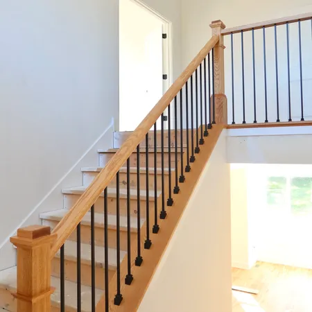 a view of staircase with railing and white walls
