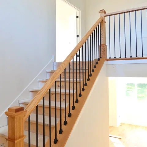a view of staircase with railing and white walls