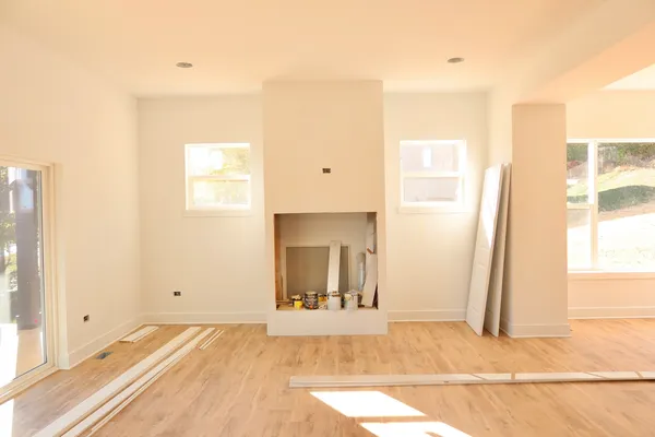 a view of a room with wooden floor and a window