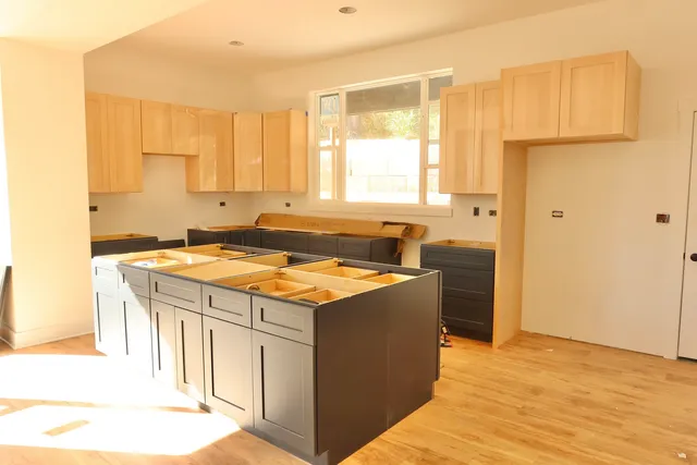 a kitchen with a stove a sink and a refrigerator
