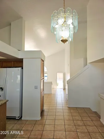 a kitchen with stainless steel appliances granite countertop a stove a sink a refrigerator and a granite counter tops