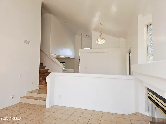 a view of a hallway with wooden floor and a living room