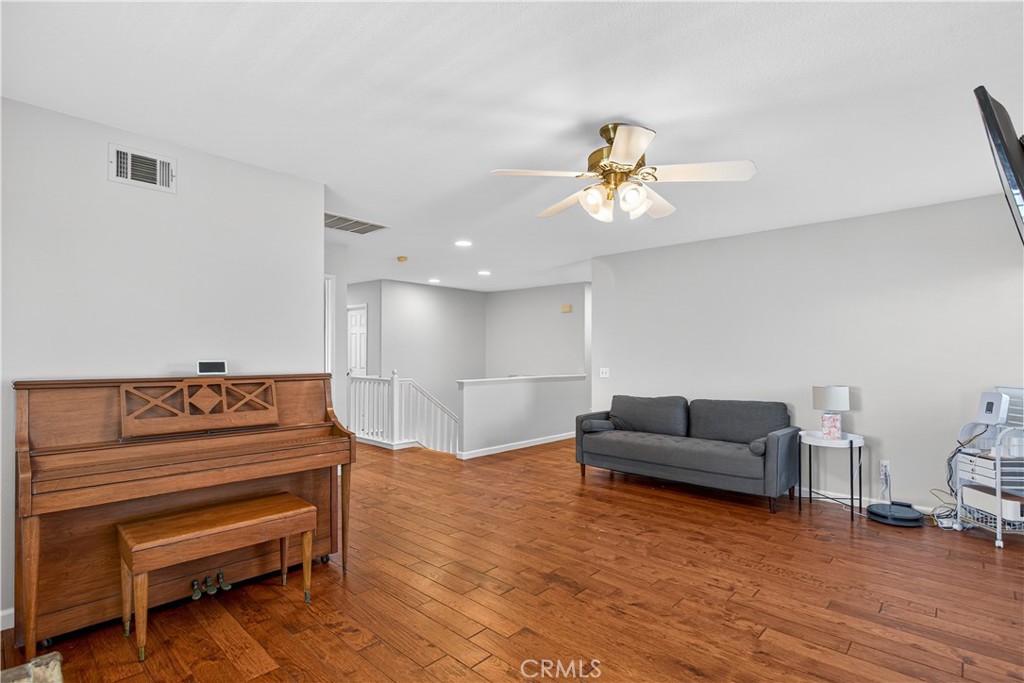 31928 Cercle Chambertin Temecula, CA 92591 - Photo 50 of 74 a living room with furniture and wooden floor