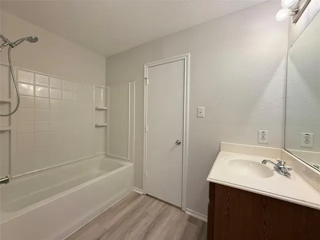 a bathroom with a bathtub a sink and a shower