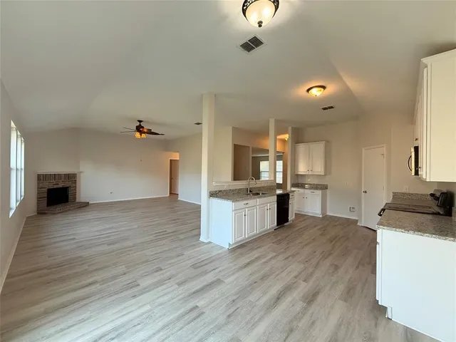 a view of a kitchen with microwave and cabinets