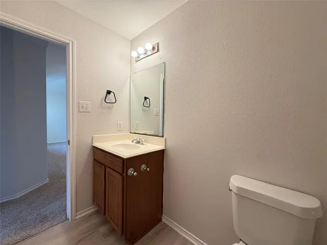 a bathroom with a sink toilet and mirror