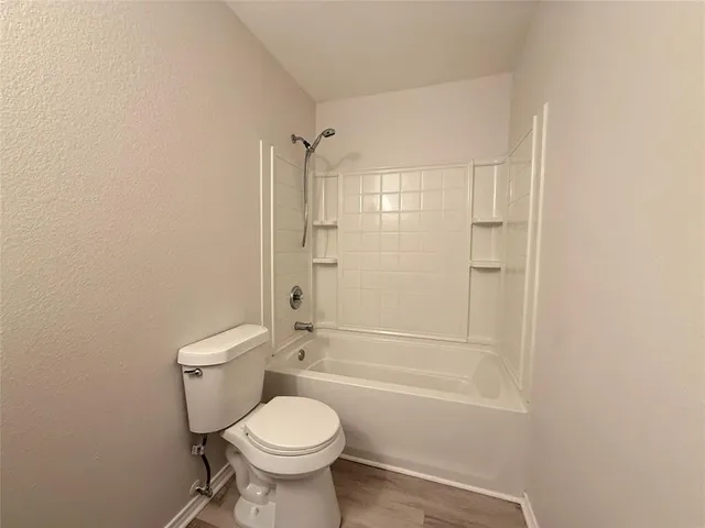 a bathroom with a toilet sink and shower