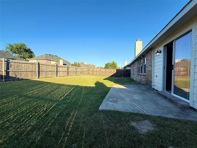 a view of a house with a yard and sitting area