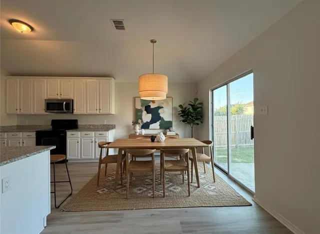 a view of a dining room with furniture window and wooden floor