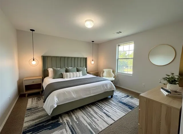 a bedroom with a bed and window