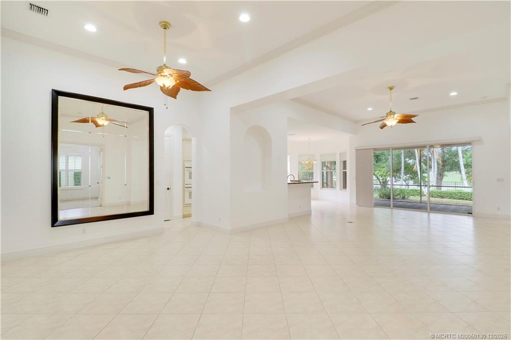 736 Southwest Pebble Lane Palm City, FL 34990 - Photo 1 of 54 a view of a big room with windows and chandelier