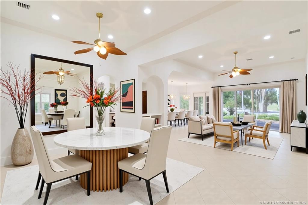 736 Southwest Pebble Lane Palm City, FL 34990 - Photo 3 of 54 a dining room with furniture a potted plant and a chandelier