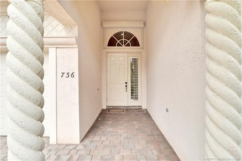 736 Southwest Pebble Lane Palm City, FL 34990 - Photo 34 of 54 a view of a hallway with wooden floor and windows