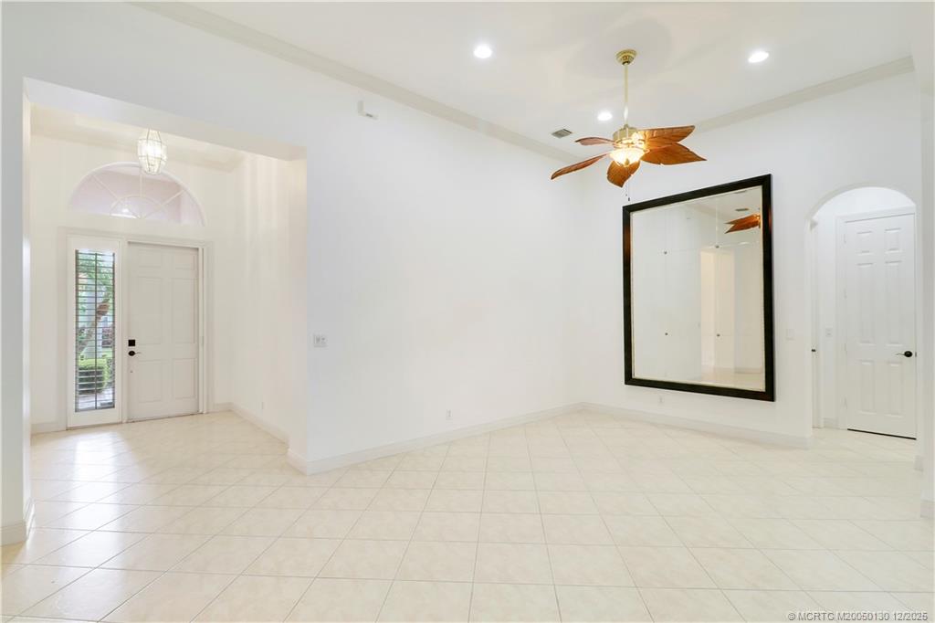 736 Southwest Pebble Lane Palm City, FL 34990 - Photo 4 of 54 an empty room with windows and a ceiling fan