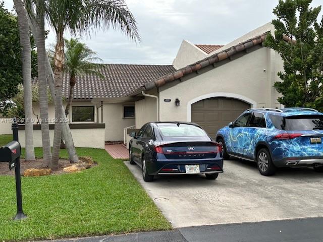a couple of cars parked in front of a house