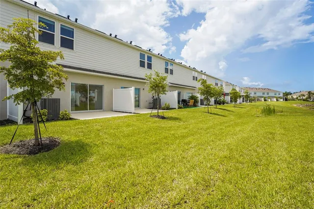 a swimming pool with outdoor seating and yard