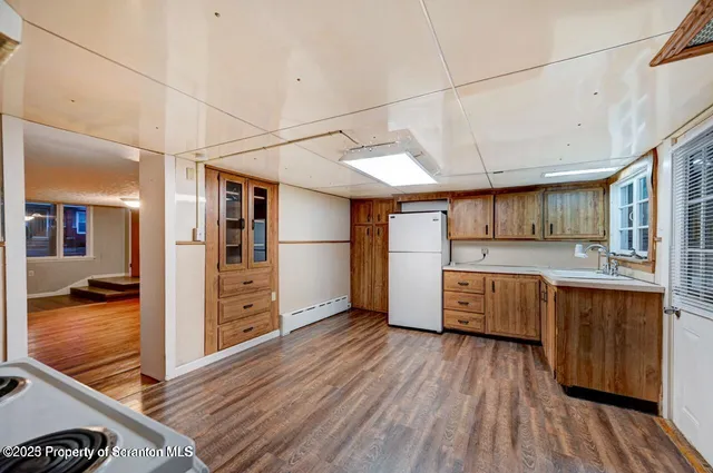 a kitchen with refrigerator and cabinets