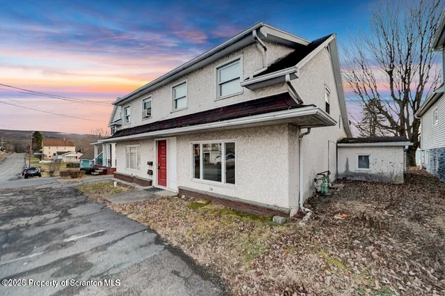 a front view of a house with parking space