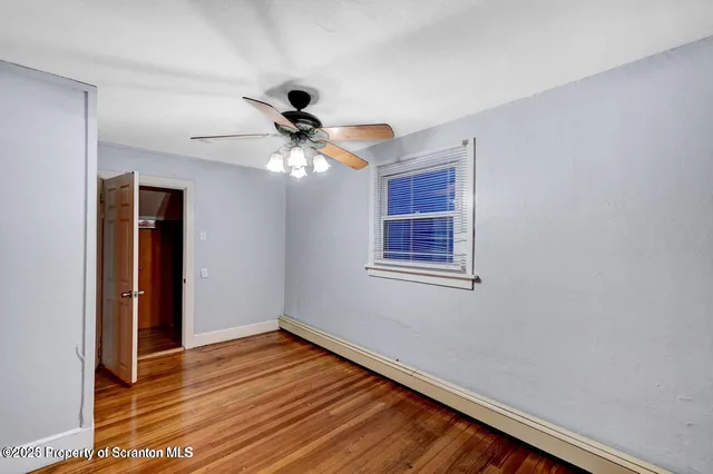 a room with a wooden floor and furniture