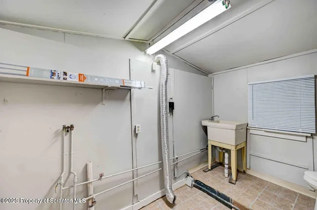 a kitchen with stainless steel appliances a stove top oven a sink dishwasher and a refrigerator with wooden floor