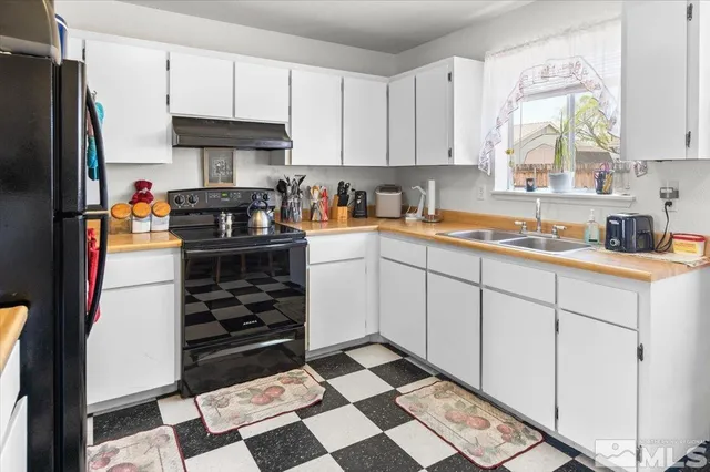a kitchen with stainless steel appliances a stove a sink and a refrigerator