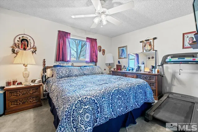 a bedroom with bed and window