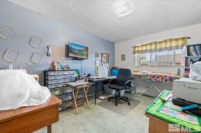 a kitchen that has a lot of cabinets a refrigerator and a dining table
