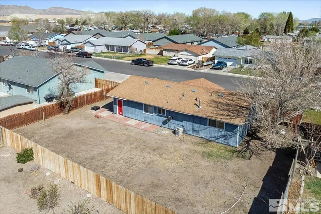 an aerial view of residential houses and car parked on street side
