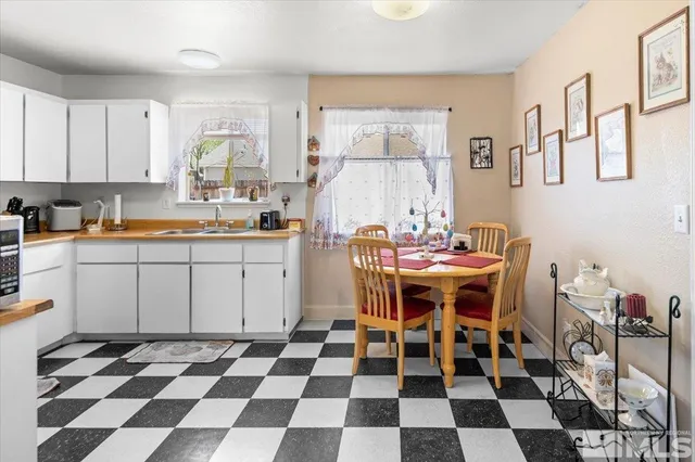a kitchen with a checkered table and chairs