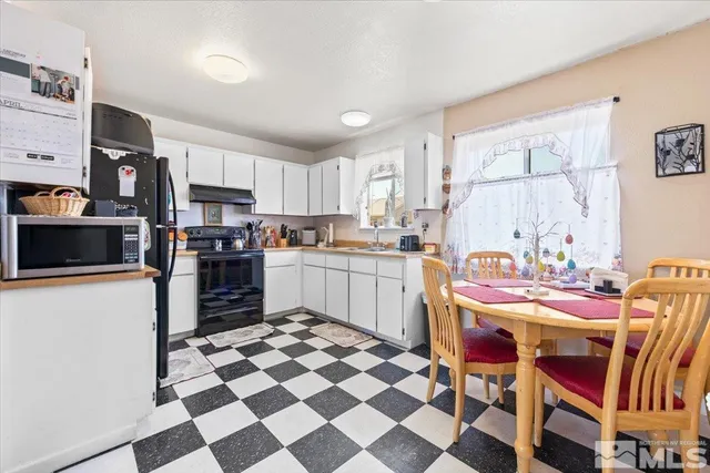 a kitchen with granite countertop stainless steel appliances a sink and a counter top space