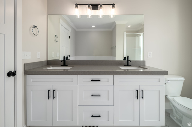 8797 Green Way, Unit 3 Sandy, UT 84094 - Photo 8 of 12 Bathroom featuring double vanity, a stall shower, and crown molding