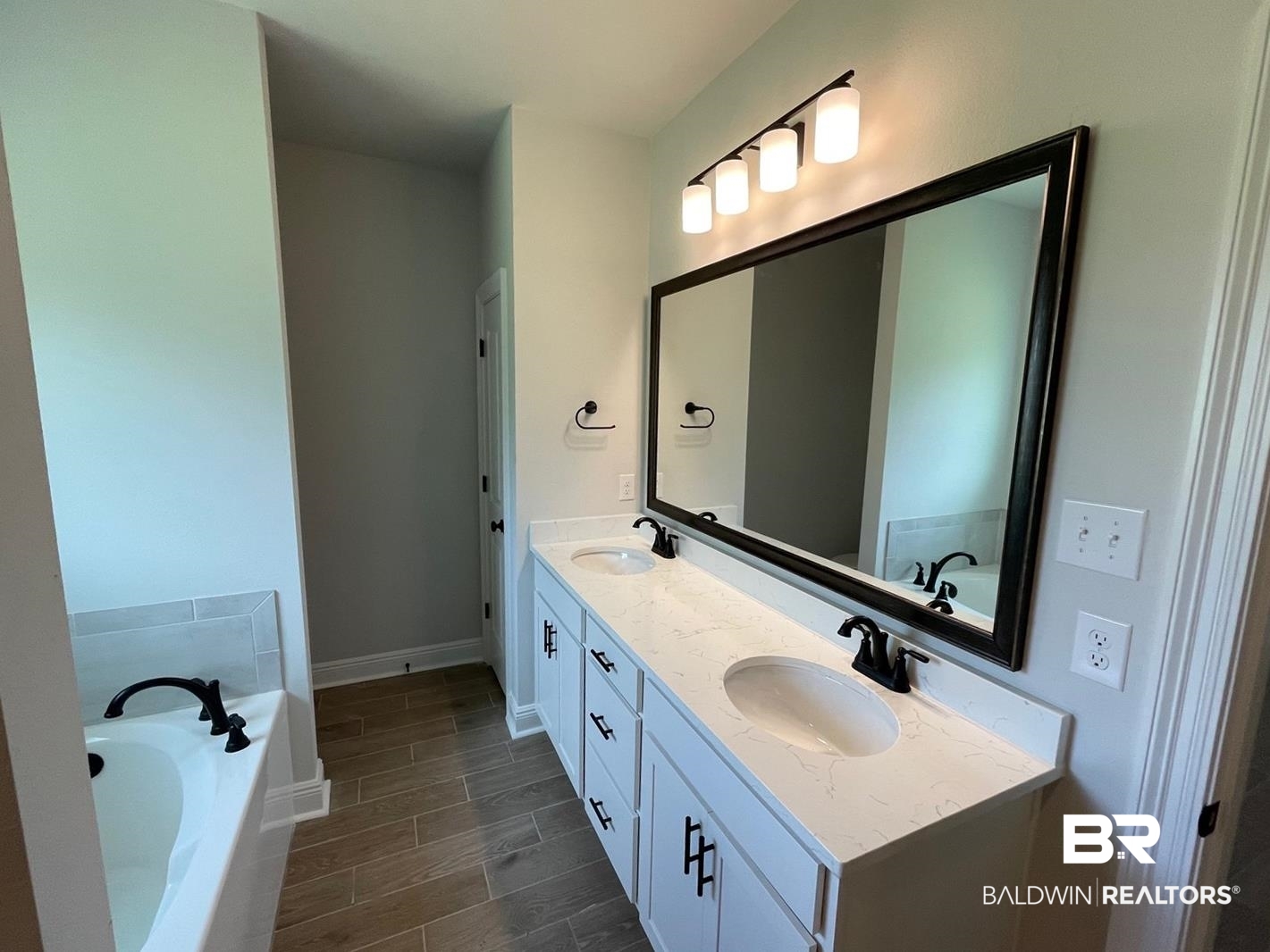 1626 Fenton Circle Foley, AL 36535 - Photo 7 of 16 Bathroom with a bathing tub, tile patterned flooring, and double vanity