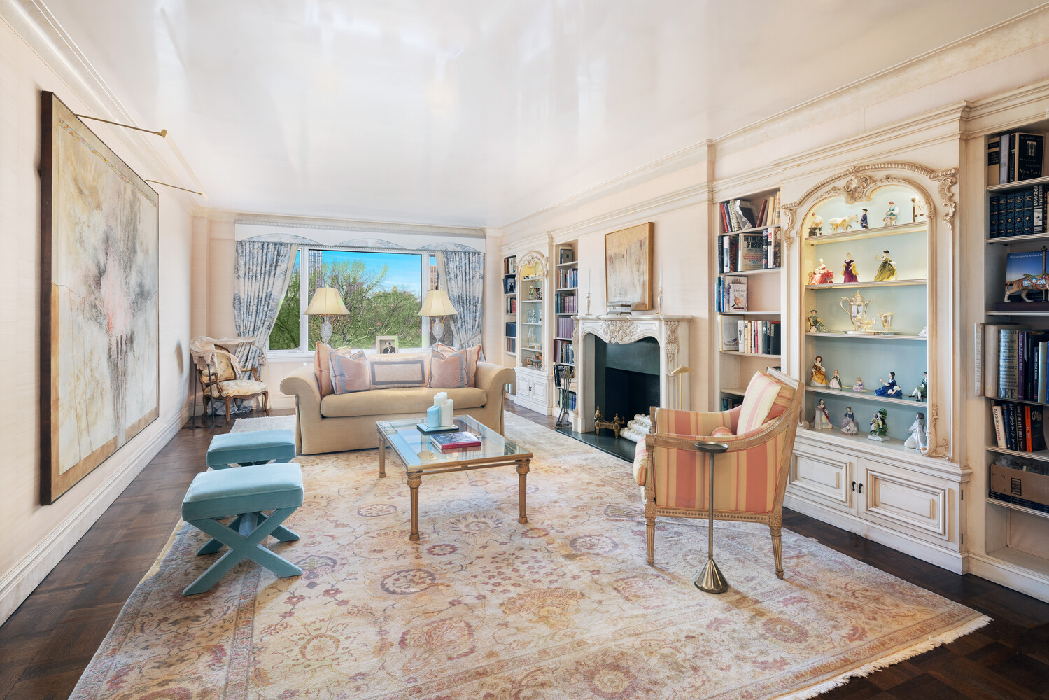a living room with fireplace furniture and a rug