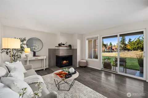 a living room with furniture fireplace and window