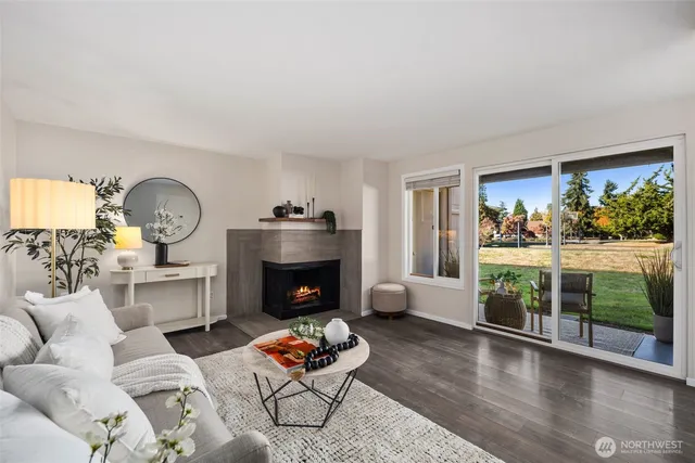 a living room with furniture fireplace and window