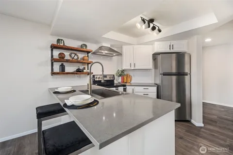 a dining room with furniture and a potted plant