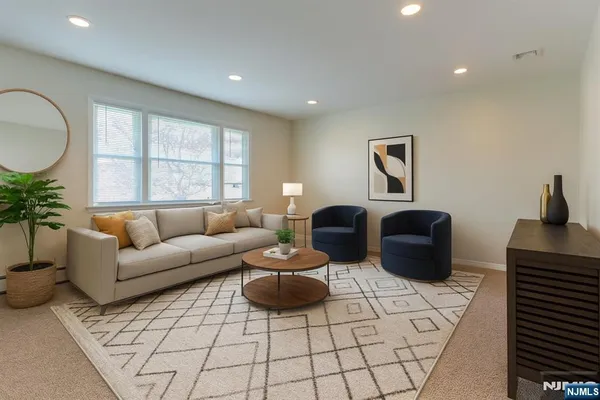 a living room with furniture a rug and a window