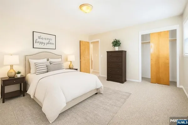 a bedroom with a bed and a painting