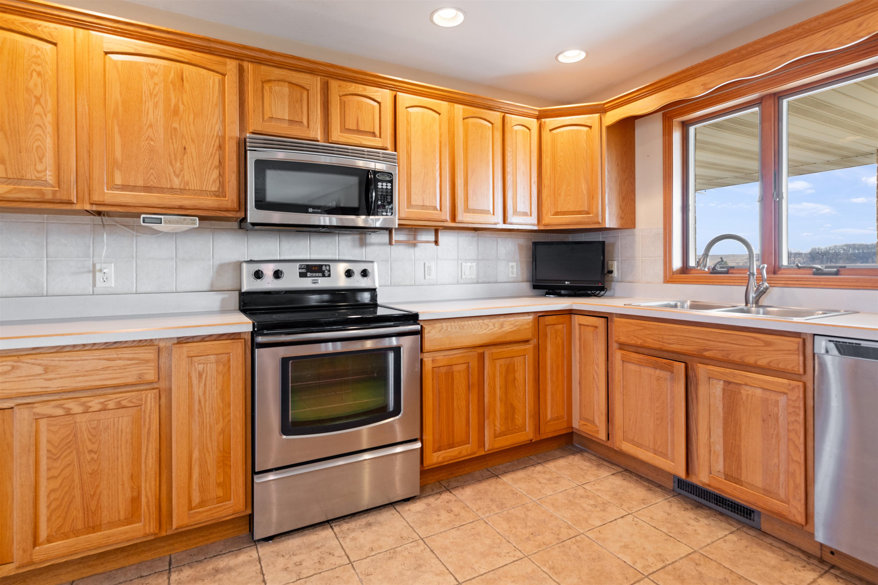 2188 West Cedarville Road Freeport, IL 61032 - Photo 5 of 33 a kitchen with stainless steel appliances granite countertop a stove sink and microwave