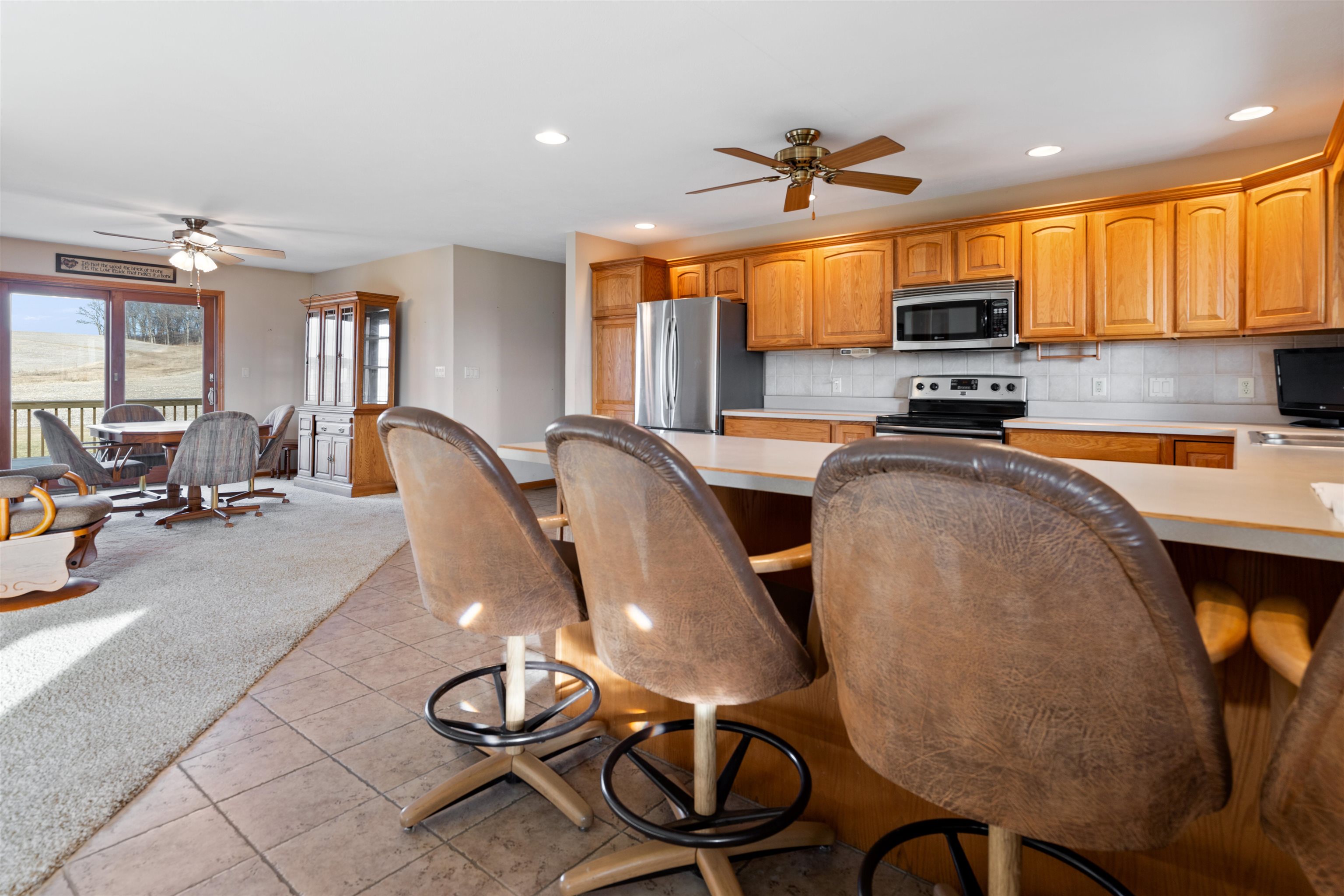 2188 West Cedarville Road Freeport, IL 61032 - Photo 6 of 33 a kitchen with stainless steel appliances a sink a stove a refrigerator cabinets and dining table