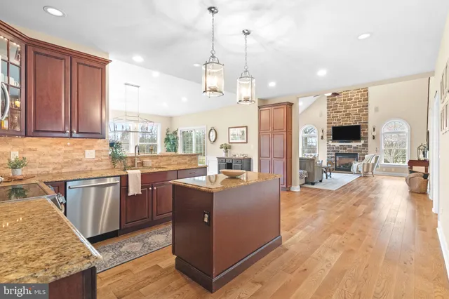 a view of a hallway with wooden floor and furniture