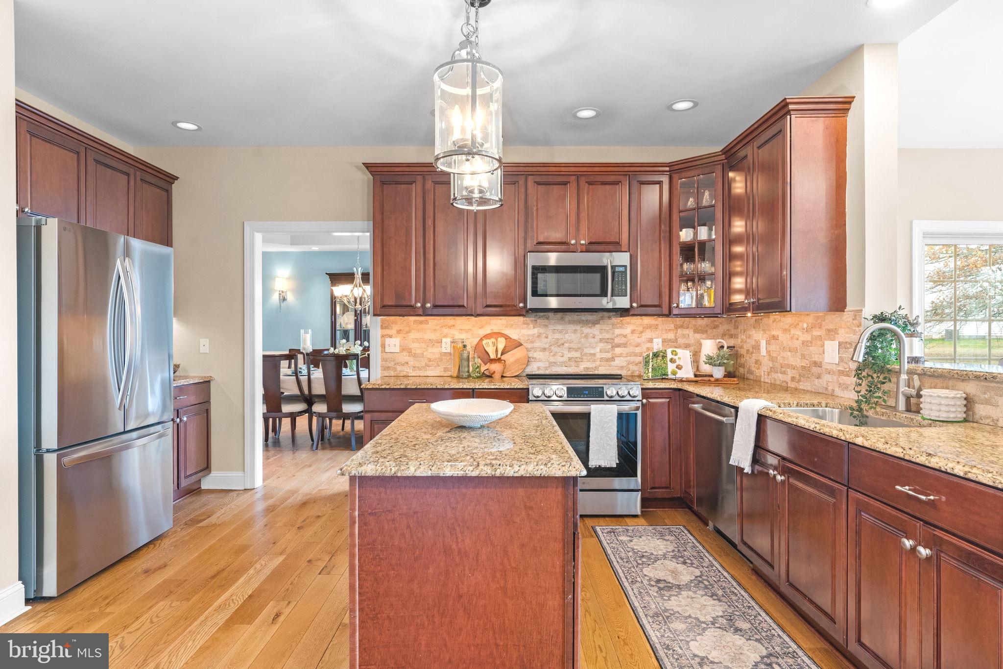 3320 Fisher Road Lansdale, PA 19446 - Photo 21 of 65 a kitchen with stainless steel appliances granite countertop a refrigerator a sink dishwasher a stove with wooden cabinets and floor