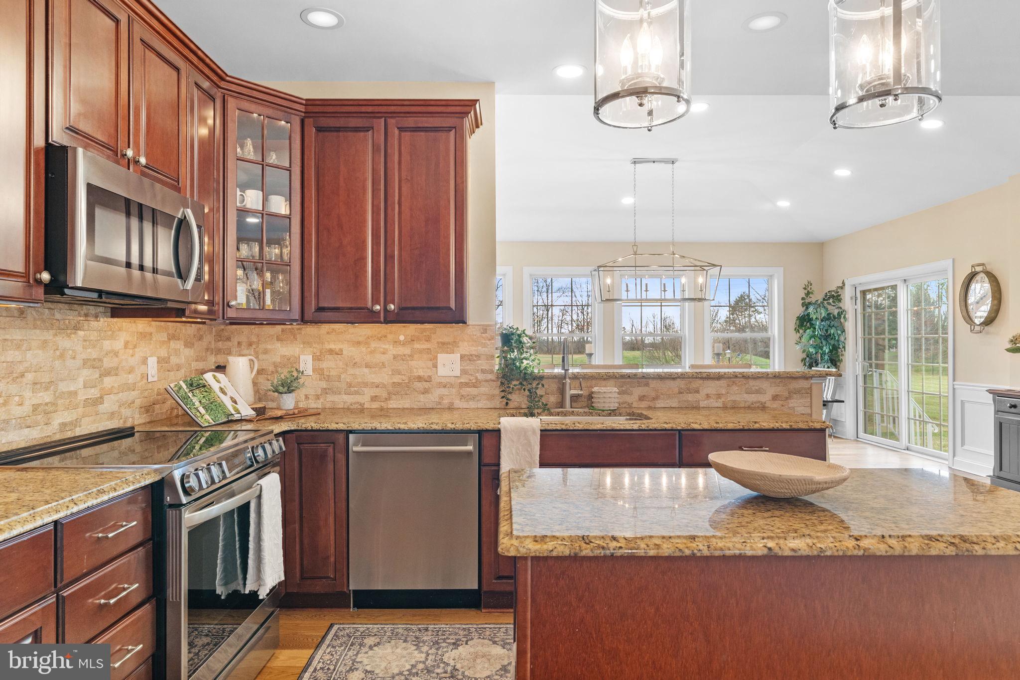 3320 Fisher Road Lansdale, PA 19446 - Photo 23 of 65 a kitchen with stainless steel appliances granite countertop a sink stove and cabinets