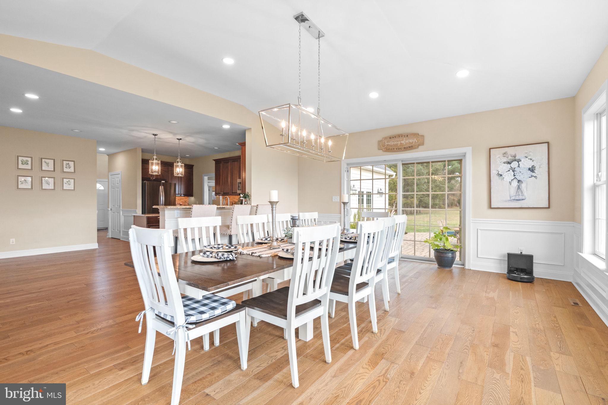 3320 Fisher Road Lansdale, PA 19446 - Photo 25 of 65 a dining room with wooden floor a chandelier a glass table and chairs
