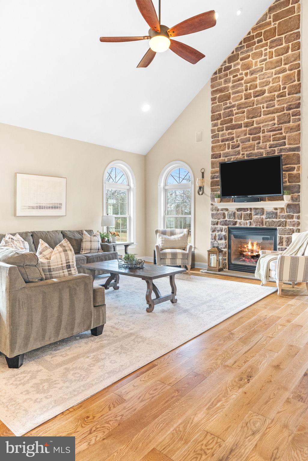 3320 Fisher Road Lansdale, PA 19446 - Photo 30 of 65 a living room with furniture a flat screen tv and a fireplace