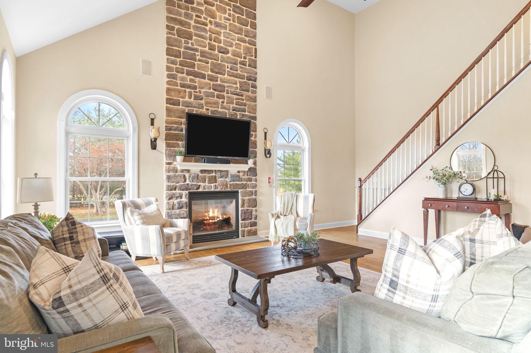 3320 Fisher Road Lansdale, PA 19446 - Photo 36 of 65 a living room with furniture a flat screen tv and a fireplace