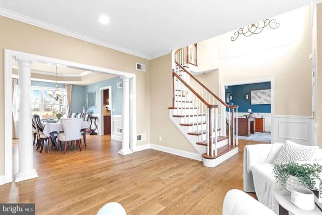 a kitchen with stainless steel appliances granite countertop a refrigerator a sink dishwasher a stove with wooden cabinets and floor