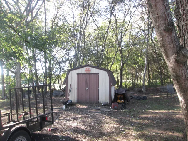 a view of a barn in the middle of a yard